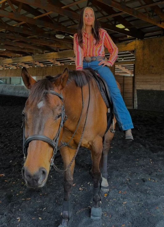 Katie on horseback in the barn